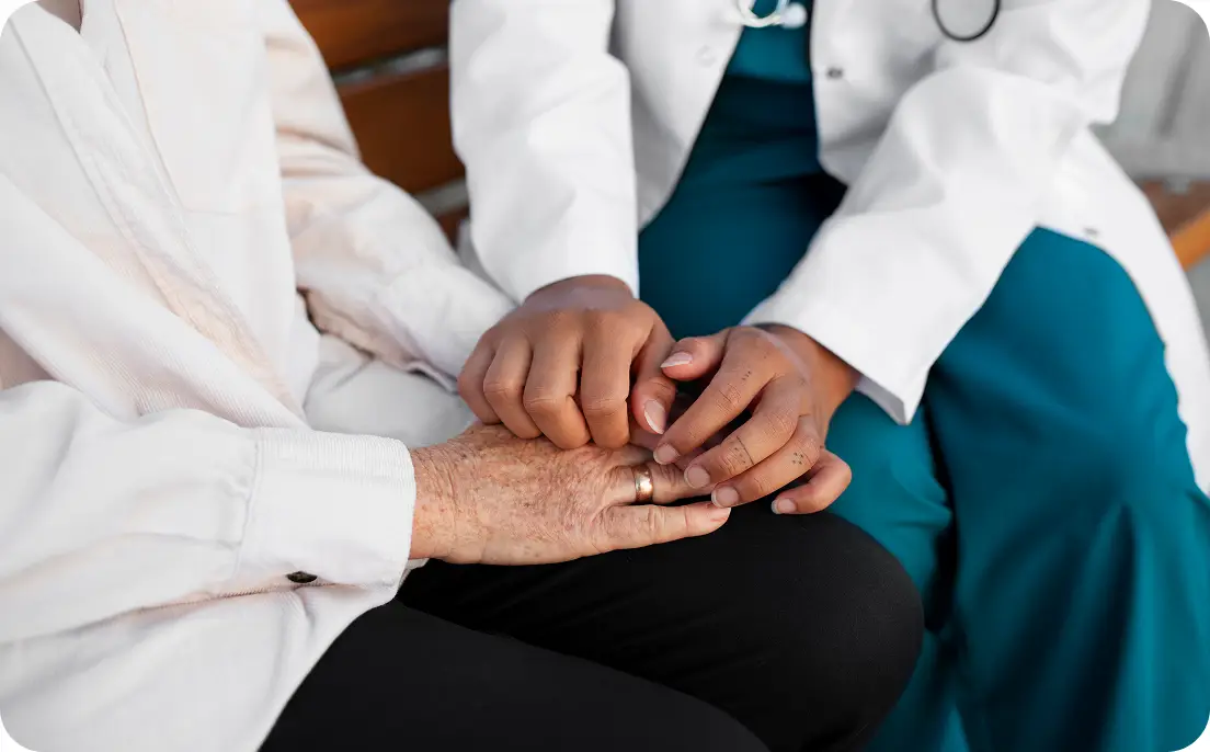 healthcare working holding patient hand