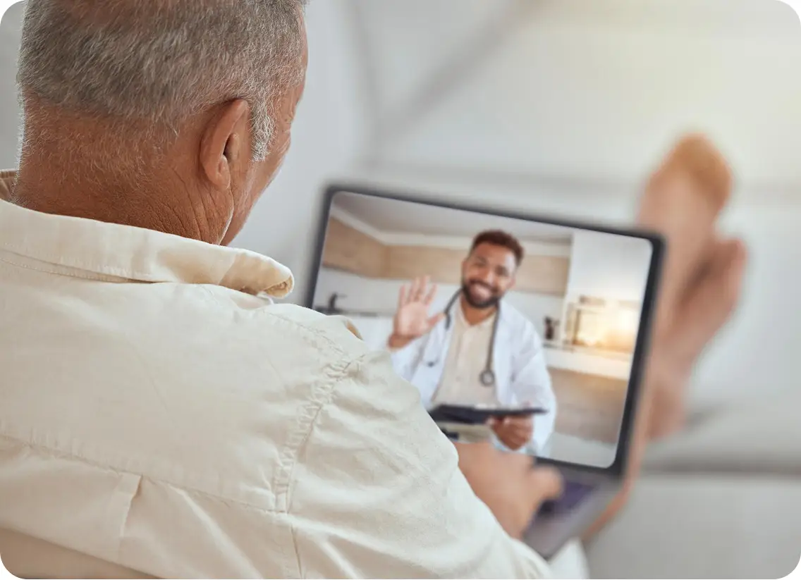 elderly man on telehealth appointment on laptop
